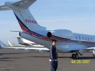 Josh behind a private jet.